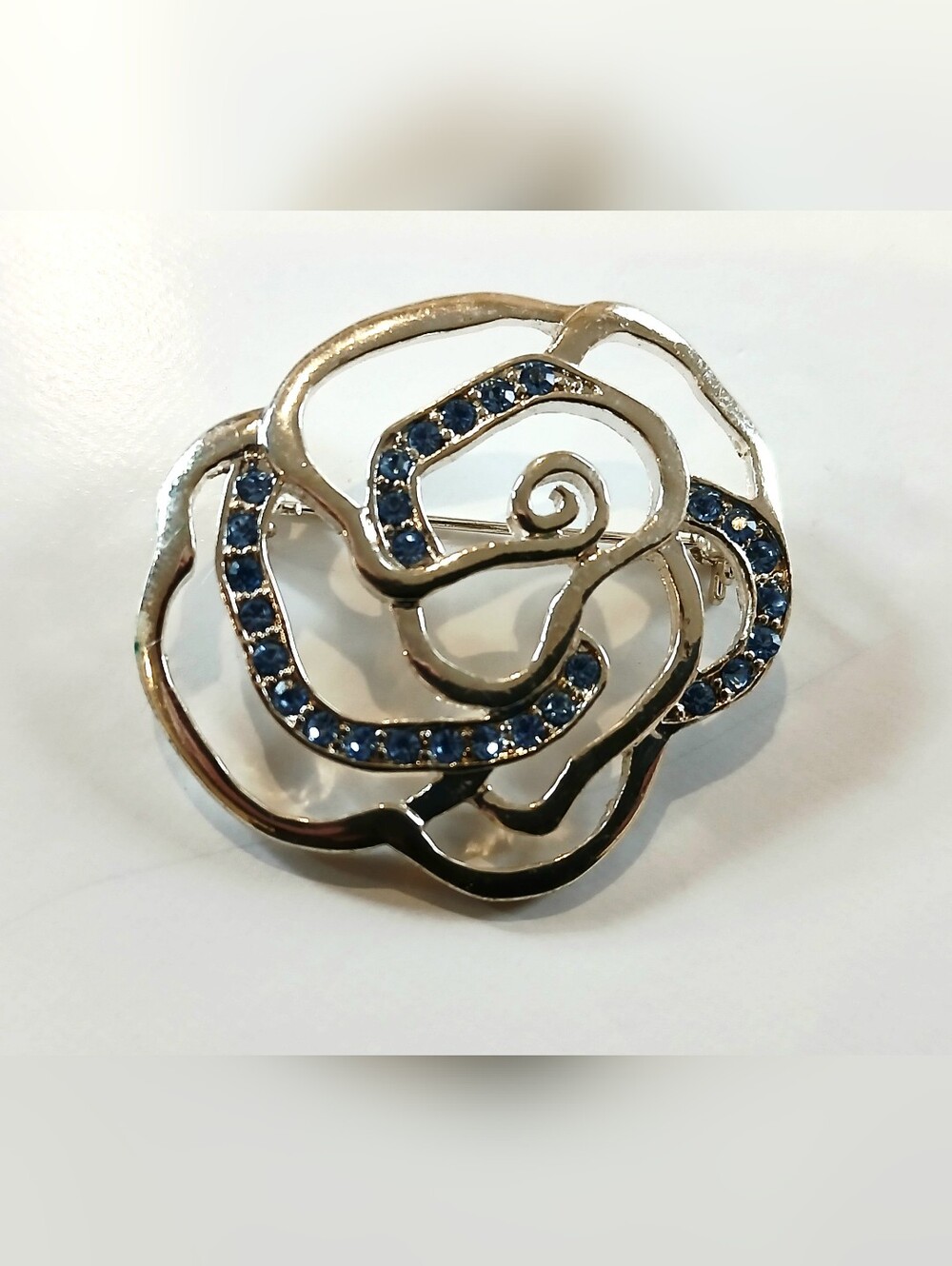 Elegant Floral Silvertone Brooch with Blue Crystal Accents - Picture 1 of 4